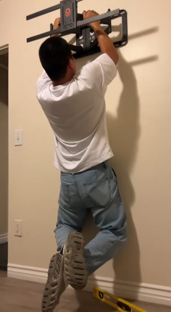 Technician installing wall mount